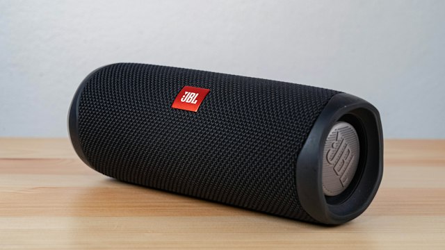 Compact wireless speaker on a surface in a home setting