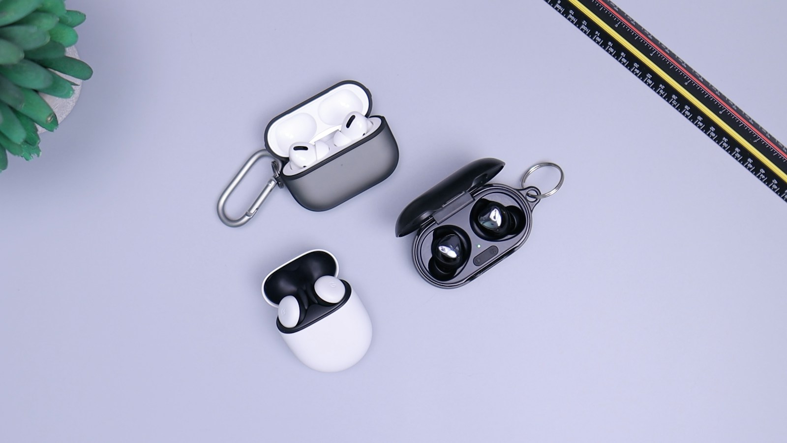 Wireless earbuds and their compact charging case on a tabletop