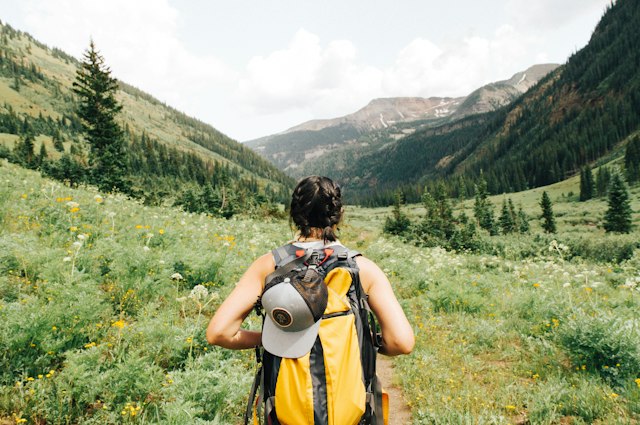 Person walking along an outdoor trail in daylight