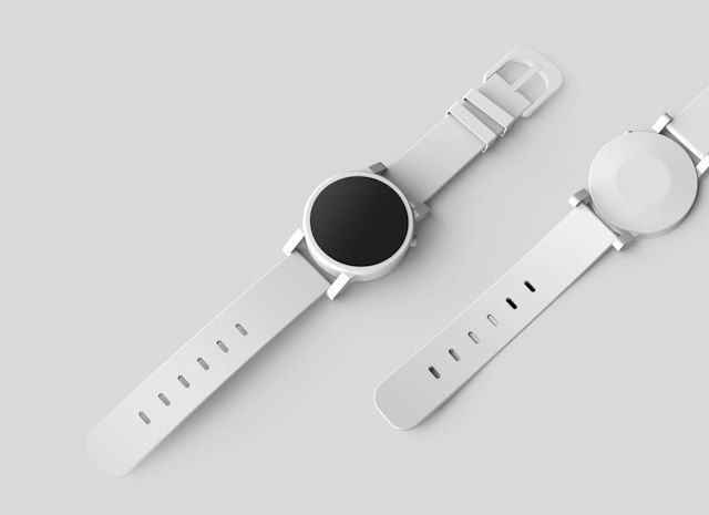 Two watches photographed on a light surface