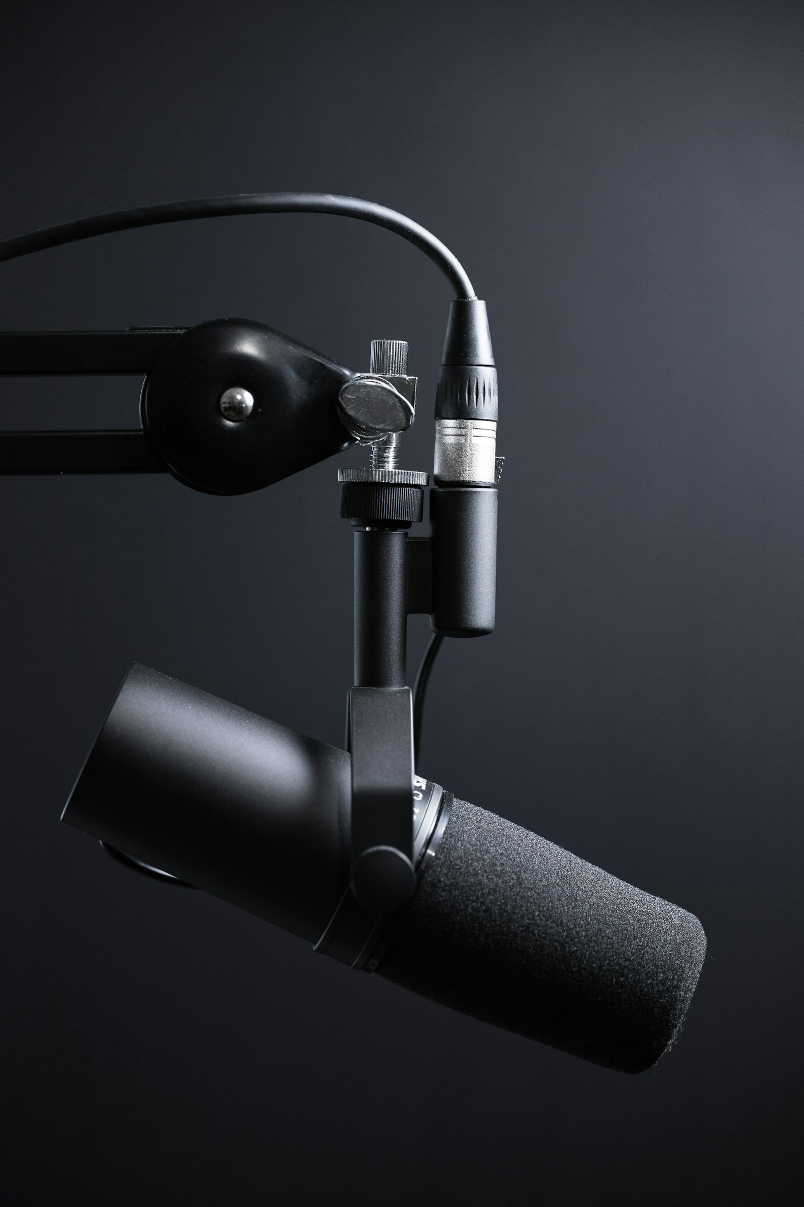 Microphone mounted near a desk for recording and conversation