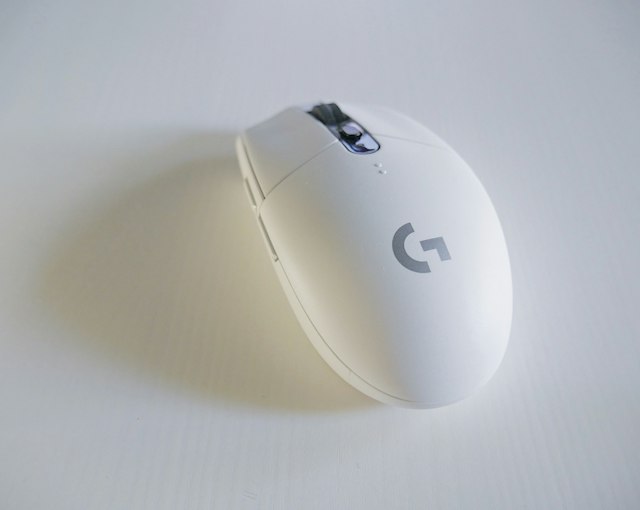 Computer mouse beside a keyboard on a desk